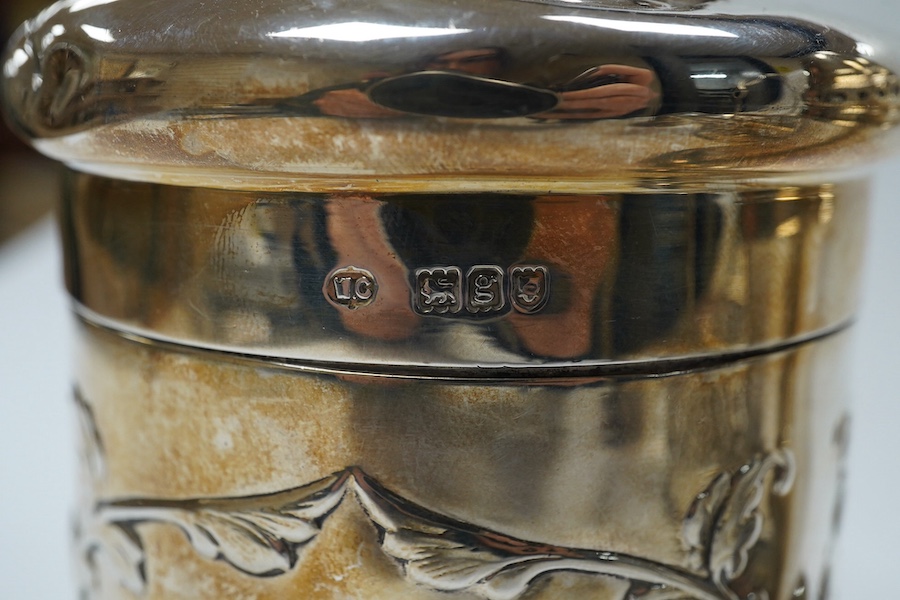 An Edwardian silver 'Reynold's Angels' silver canister, William Comyns, London, 1902, 90mm, together with a silver table perpetual lighter, silver bonbon basket and silver ring box. Condition - poor to fair